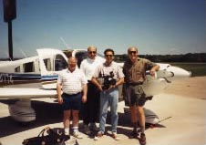 On location for Bethphage: Crew shot in front of plane. 