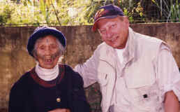 Bill with 104 year old Atayal woman. When she learned how to weave she was able to marry. Her facial tattoos signifies her coming of age. The tattoos show the family weaving pattern.